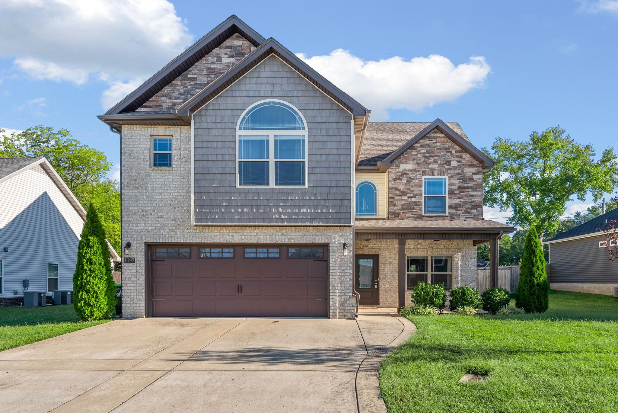 a front view of a house with a yard and garage