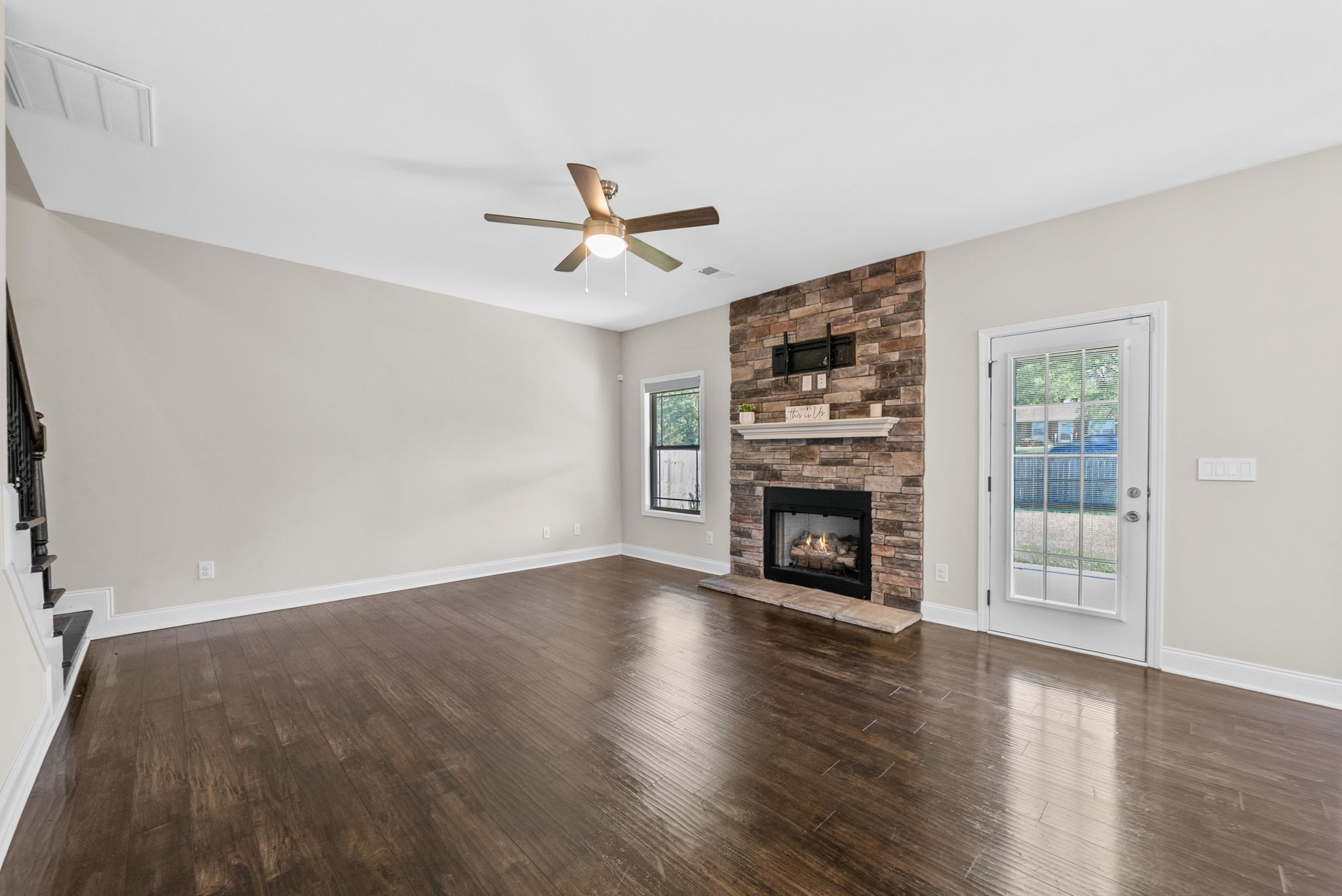 1197 Ewing Way Clarksville, TN 37043 - Photo 15 of 45 a view of a livingroom with a fireplace a ceiling fan and windows