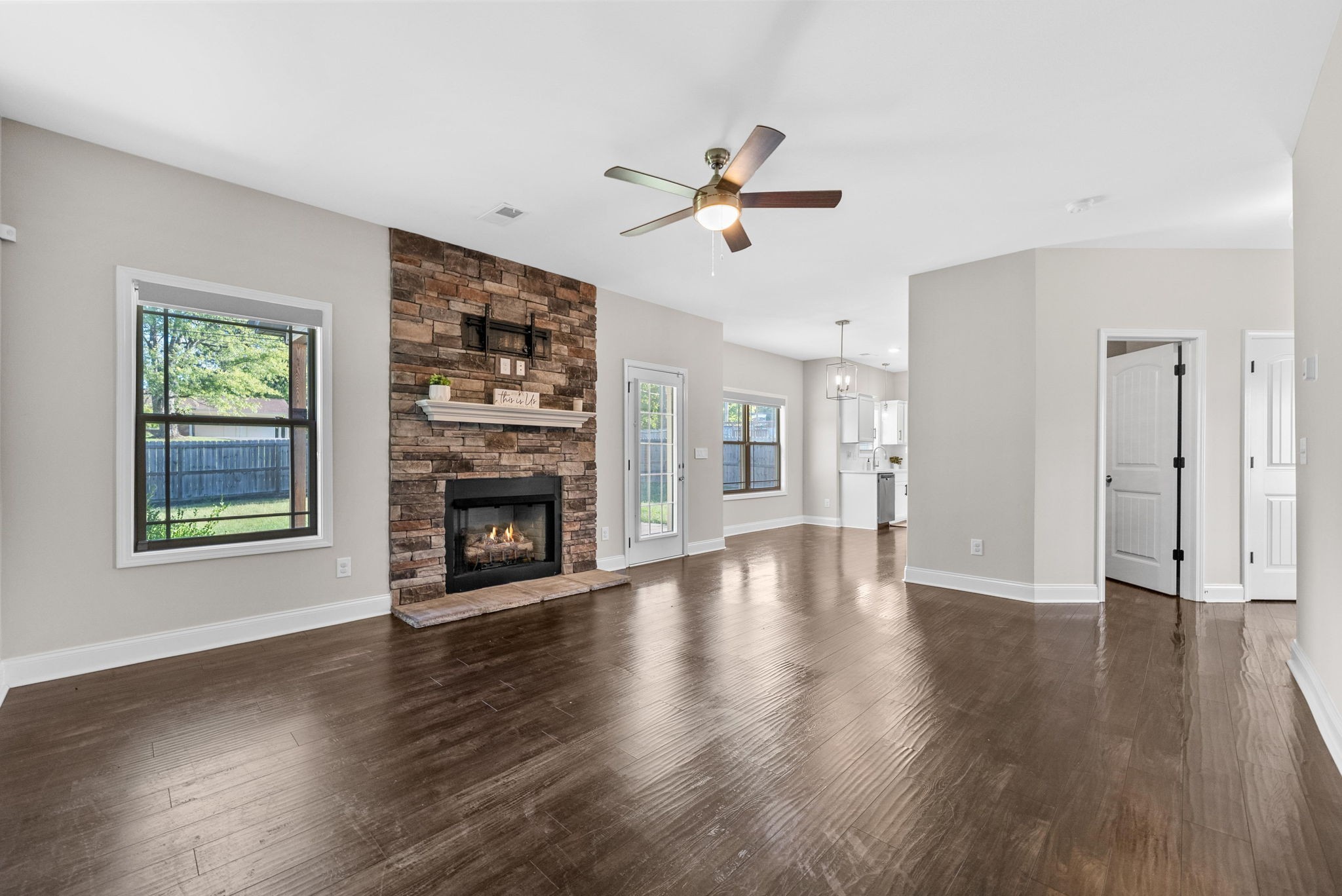 1197 Ewing Way Clarksville, TN 37043 - Photo 17 of 45 a view of a livingroom with a fireplace a ceiling fan and windows