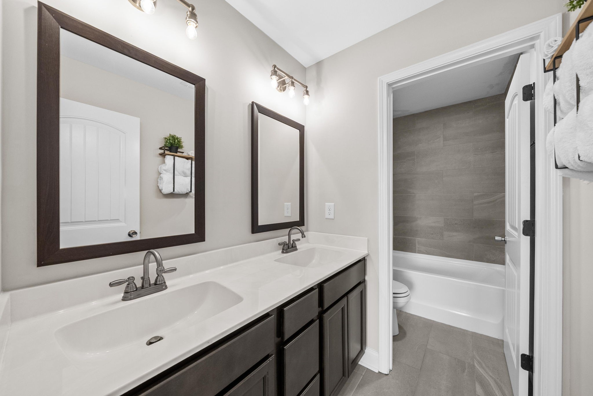 1197 Ewing Way Clarksville, TN 37043 - Photo 32 of 45 a bathroom with a bathtub shower sink vanity and mirror