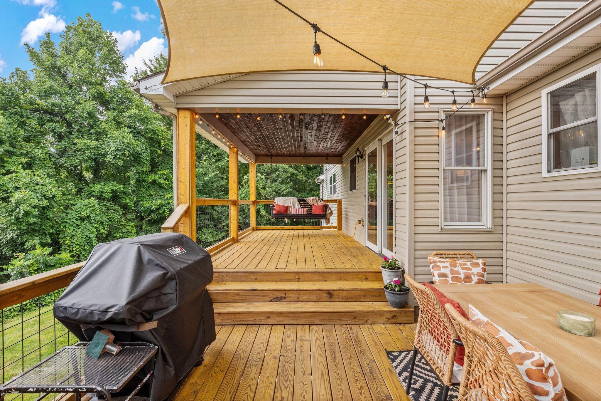 10446 Rich Hollow Road Southwest Lancaster, OH 43130 - Photo 79 of 83 Multi-level wood deck featuring a shade sail, string lighting, and direct access to interior spaces through sliding glass doors