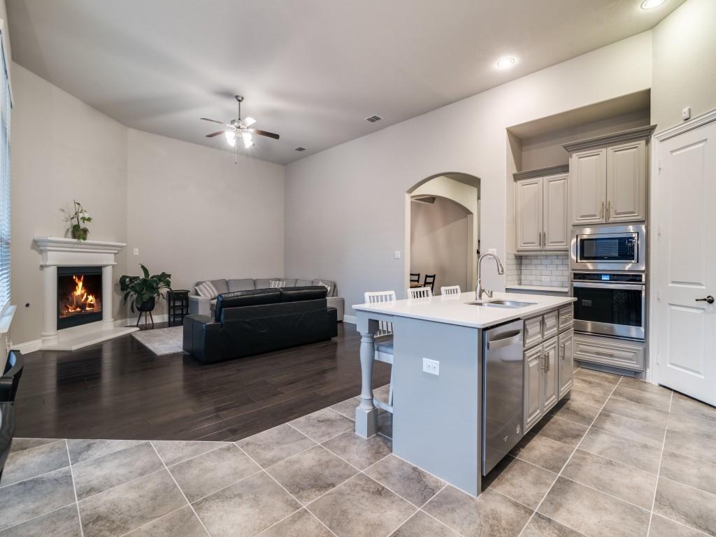 3323 Royal Ridge Drive Rockwall, TX 75087 - Photo 40 of 40 Kitchen with appliances with stainless steel finishes, arched walkways, ceiling fan, open floor plan, and recessed lighting