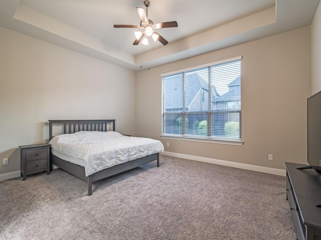 3323 Royal Ridge Drive Rockwall, TX 75087 - Photo 16 of 40 Primary Retreat with a tray ceiling and ceiling fan