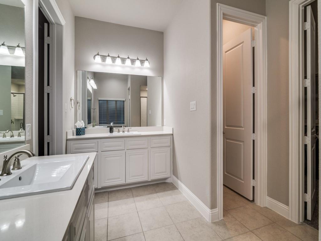 3323 Royal Ridge Drive Rockwall, TX 75087 - Photo 19 of 40 Full bathroom featuring two vanities, tile patterned floors, and an enclosed shower