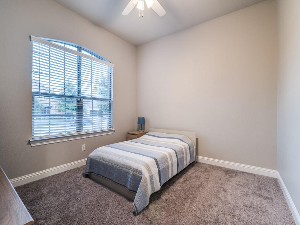 3323 Royal Ridge Drive Rockwall, TX 75087 - Photo 20 of 40 2nd Primary/ M.I.L. Bedroom FIRST FLOOR featuring multiple windows, carpet, and a ceiling fan & ensuite bathroom.