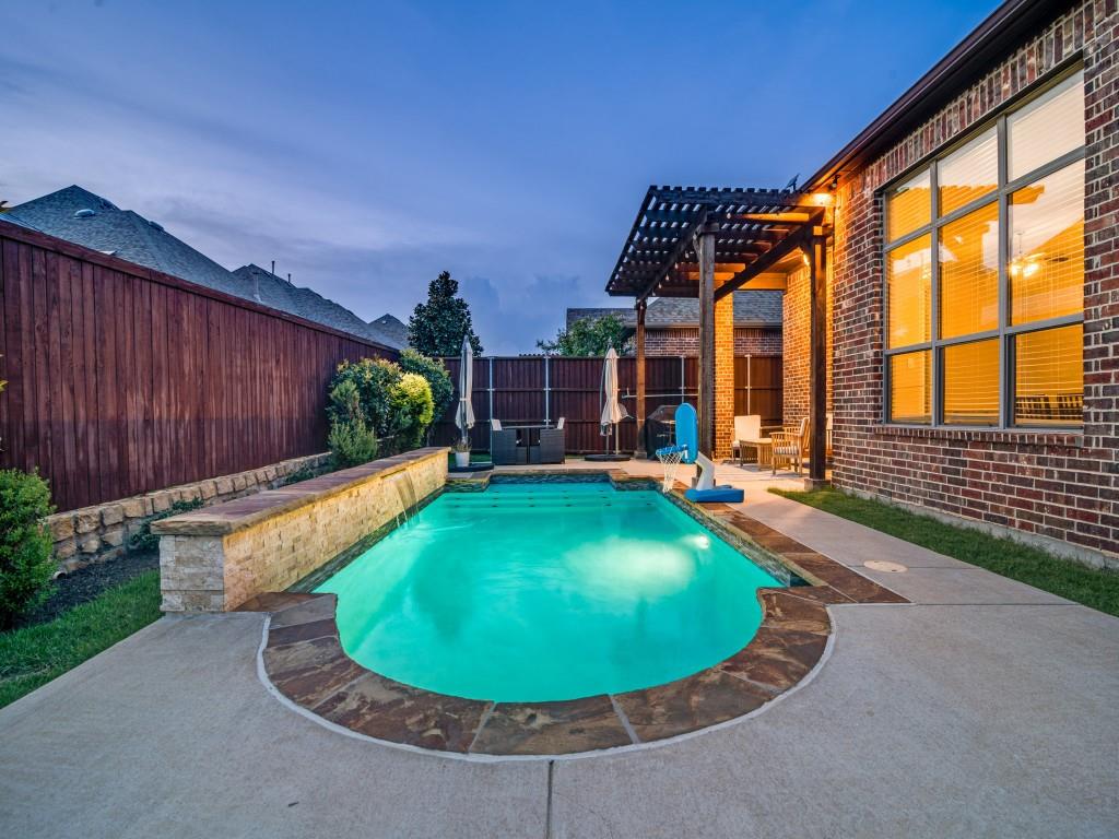 3323 Royal Ridge Drive Rockwall, TX 75087 - Photo 4 of 40 Pool at dusk with a pergola, a fenced backyard, and a patio