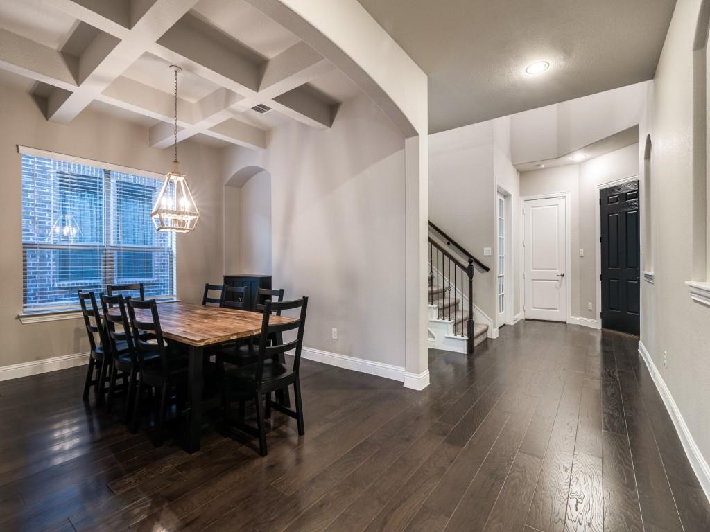3323 Royal Ridge Drive Rockwall, TX 75087 - Photo 7 of 40 Formal Dining area featuring stairs, dark wood-style flooring, arched walkways, beam ceiling, and coffered ceiling