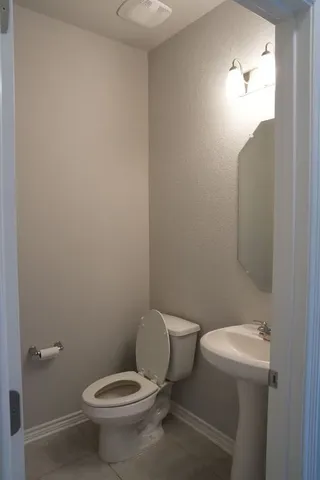 a white toilet sitting next to a bathroom sink