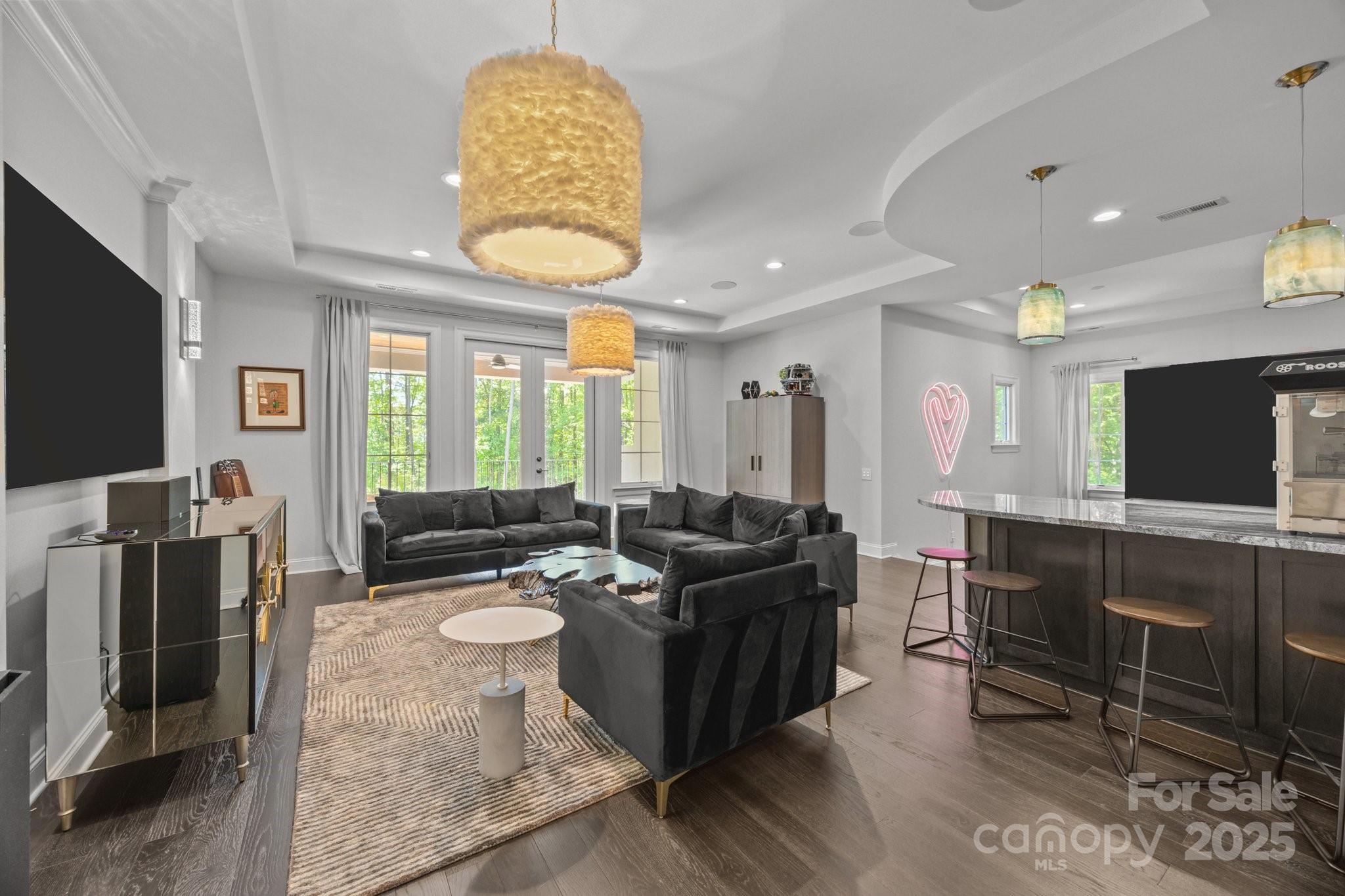 10170 Enclave Circle Concord, NC 28027 - Photo 32 of 46 a living room with furniture a flat screen tv and a large window