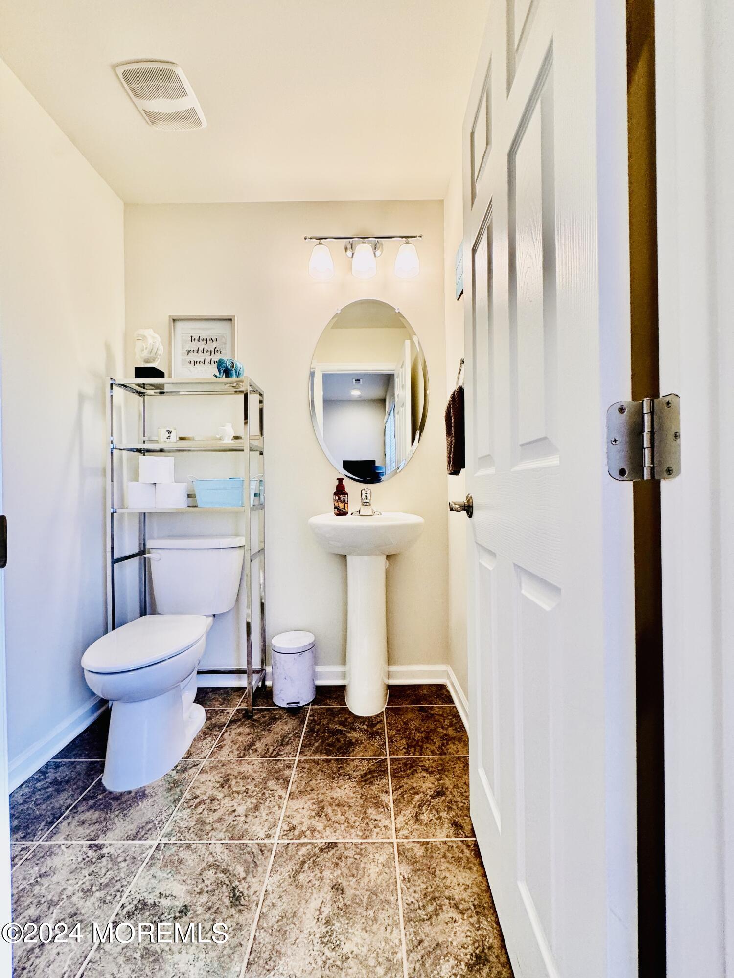 115 Beacon Lane, Unit 402 Eatontown, NJ 07724 - Photo 11 of 27 a bathroom with a toilet sink and mirror