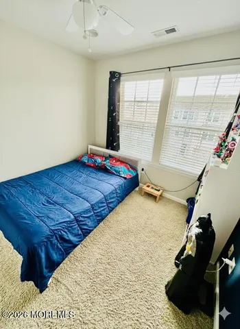 a bed sitting in a room next to a window