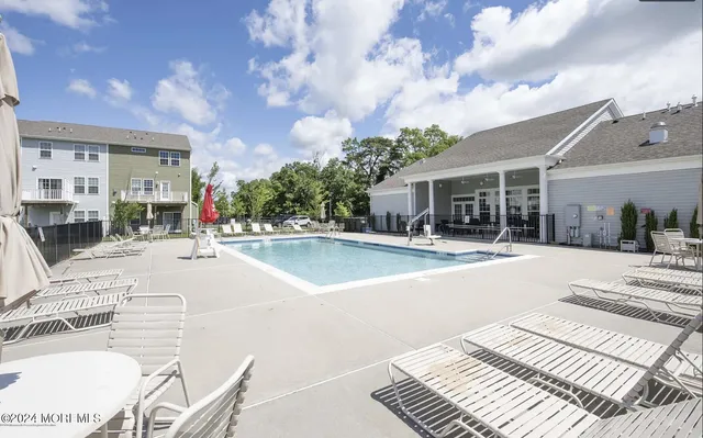 a view of a house with swimming pool and sitting area