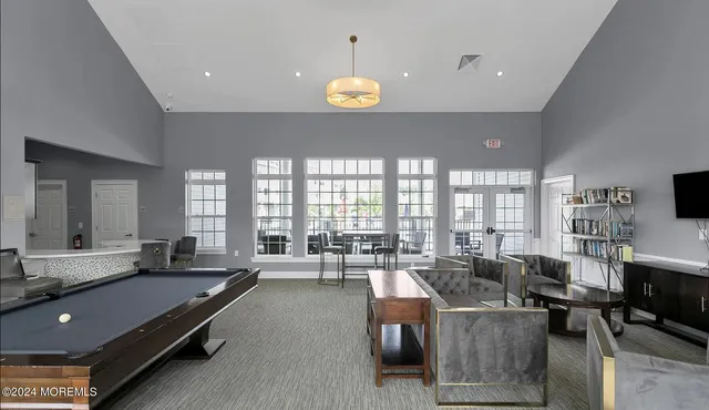 a living room with furniture a chandelier and a chandelier