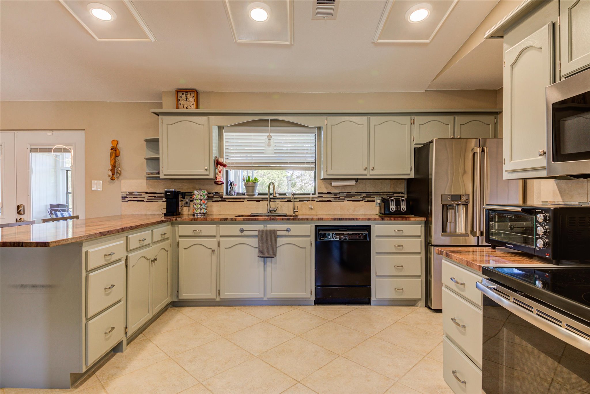 200 Harbor Circle Georgetown, TX 78633 - Photo 10 of 38 a kitchen with granite countertop a sink stainless steel appliances and cabinets