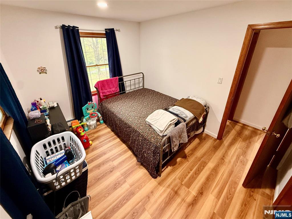 154 Cork Hill Road Franklin, NJ 07416 - Photo 15 of 35 a bedroom with a bed and wooden floor