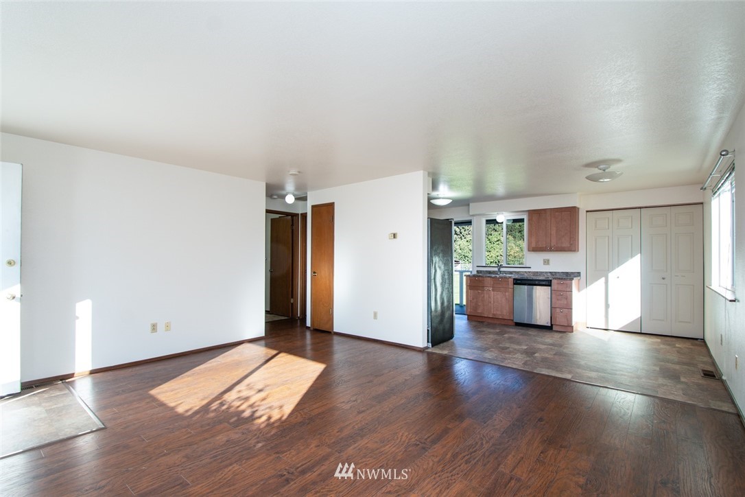 15467 Beaver Marsh Road Mount Vernon, WA 98273 - Photo 11 of 23 an empty room with wooden floor and windows