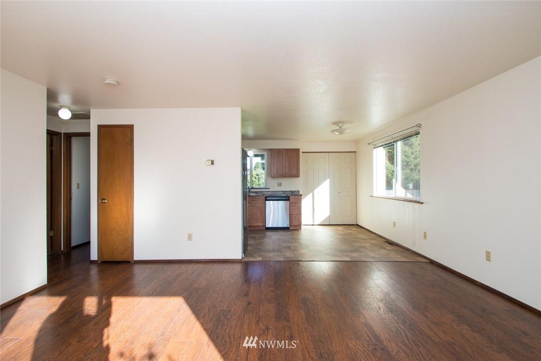 15467 Beaver Marsh Road Mount Vernon, WA 98273 - Photo 12 of 23 an empty room with wooden floor and windows