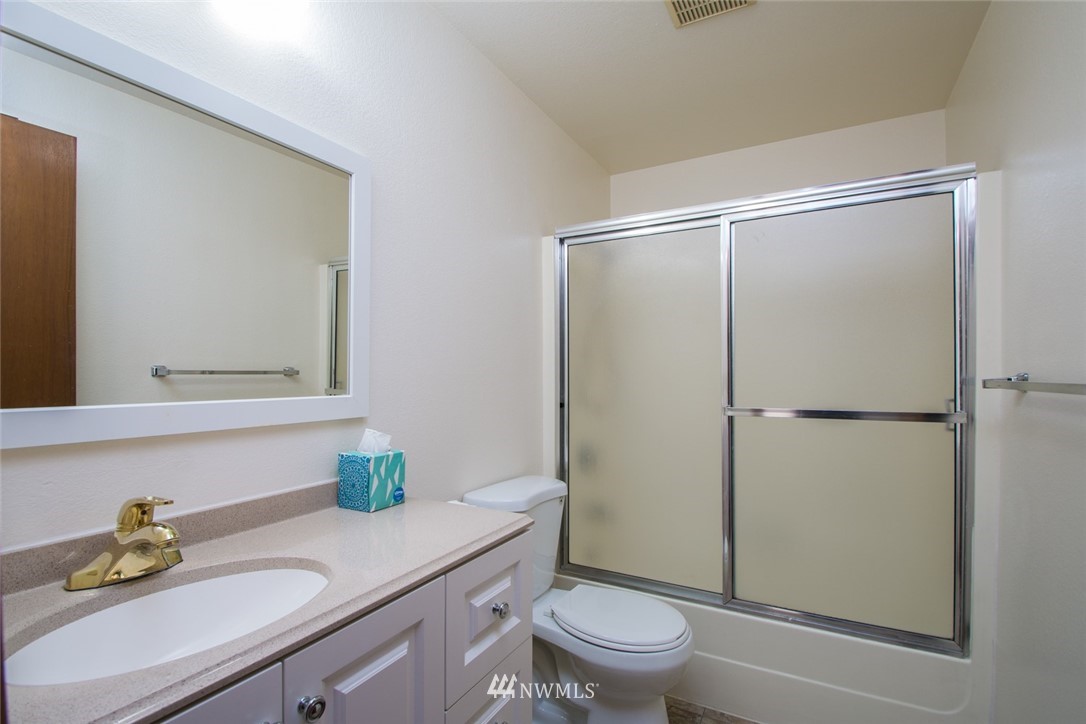 15467 Beaver Marsh Road Mount Vernon, WA 98273 - Photo 14 of 23 a bathroom with a granite countertop sink toilet and a mirror