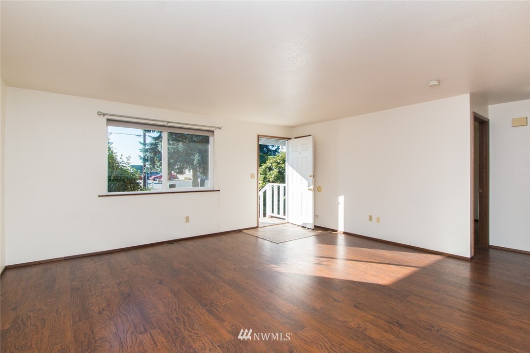 15467 Beaver Marsh Road Mount Vernon, WA 98273 - Photo 16 of 23 a view of an empty room with wooden floor and a window