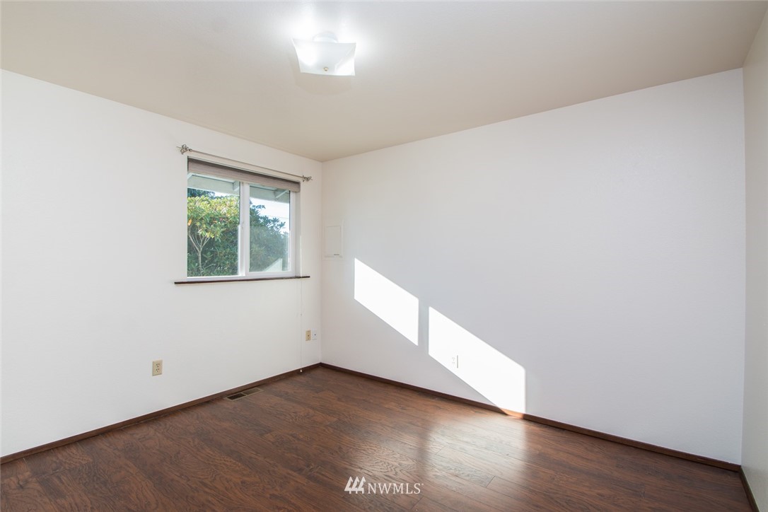 15467 Beaver Marsh Road Mount Vernon, WA 98273 - Photo 17 of 23 an empty room with wooden floor and windows
