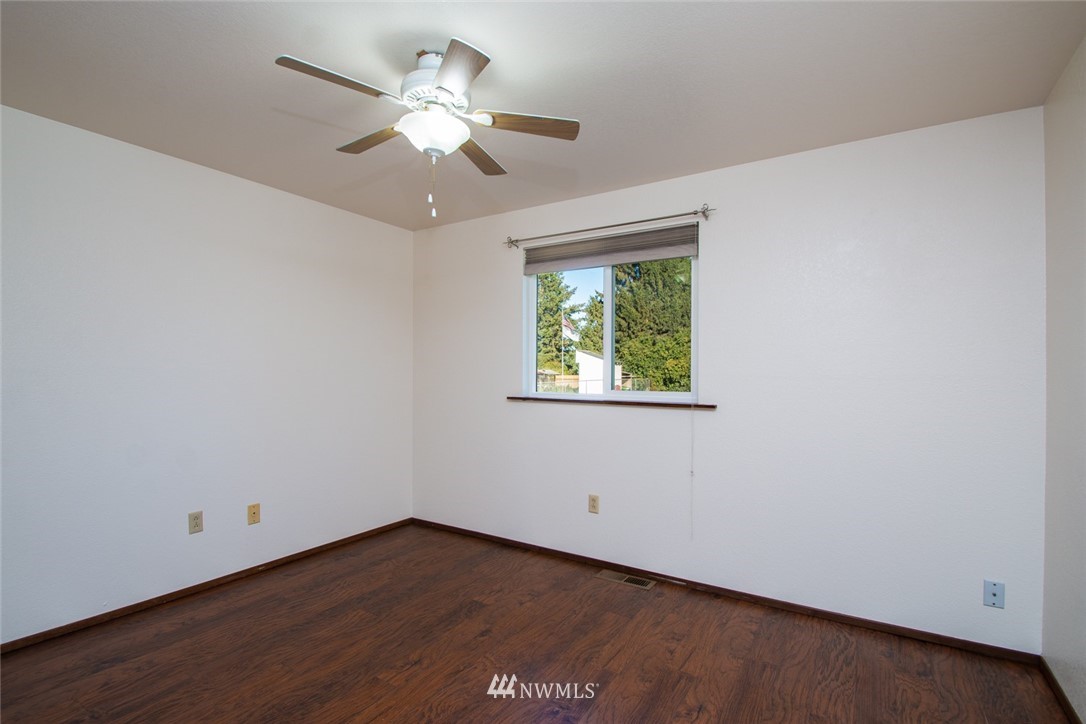 15467 Beaver Marsh Road Mount Vernon, WA 98273 - Photo 19 of 23 an empty room with a window and a fan