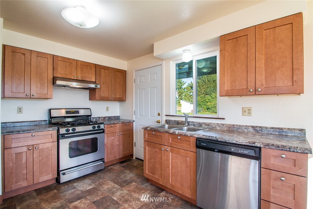 15467 Beaver Marsh Road Mount Vernon, WA 98273 - Photo 6 of 23 a kitchen with stainless steel appliances granite countertop a sink stove and cabinets