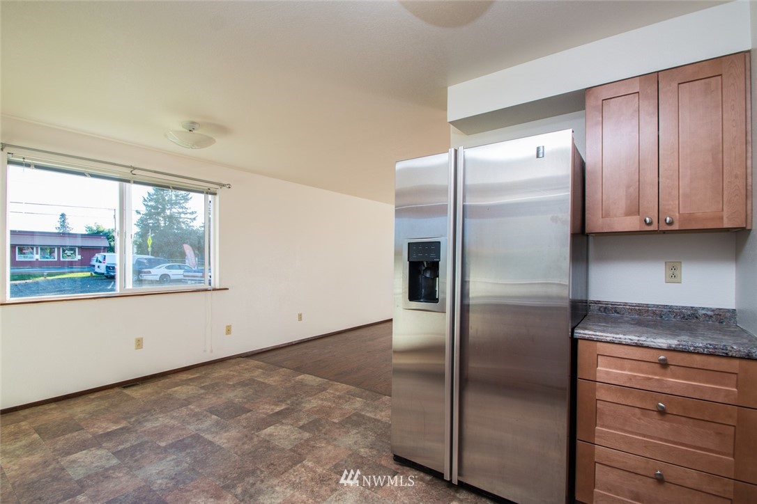 15467 Beaver Marsh Road Mount Vernon, WA 98273 - Photo 7 of 23 a kitchen with granite countertop a refrigerator and natural light