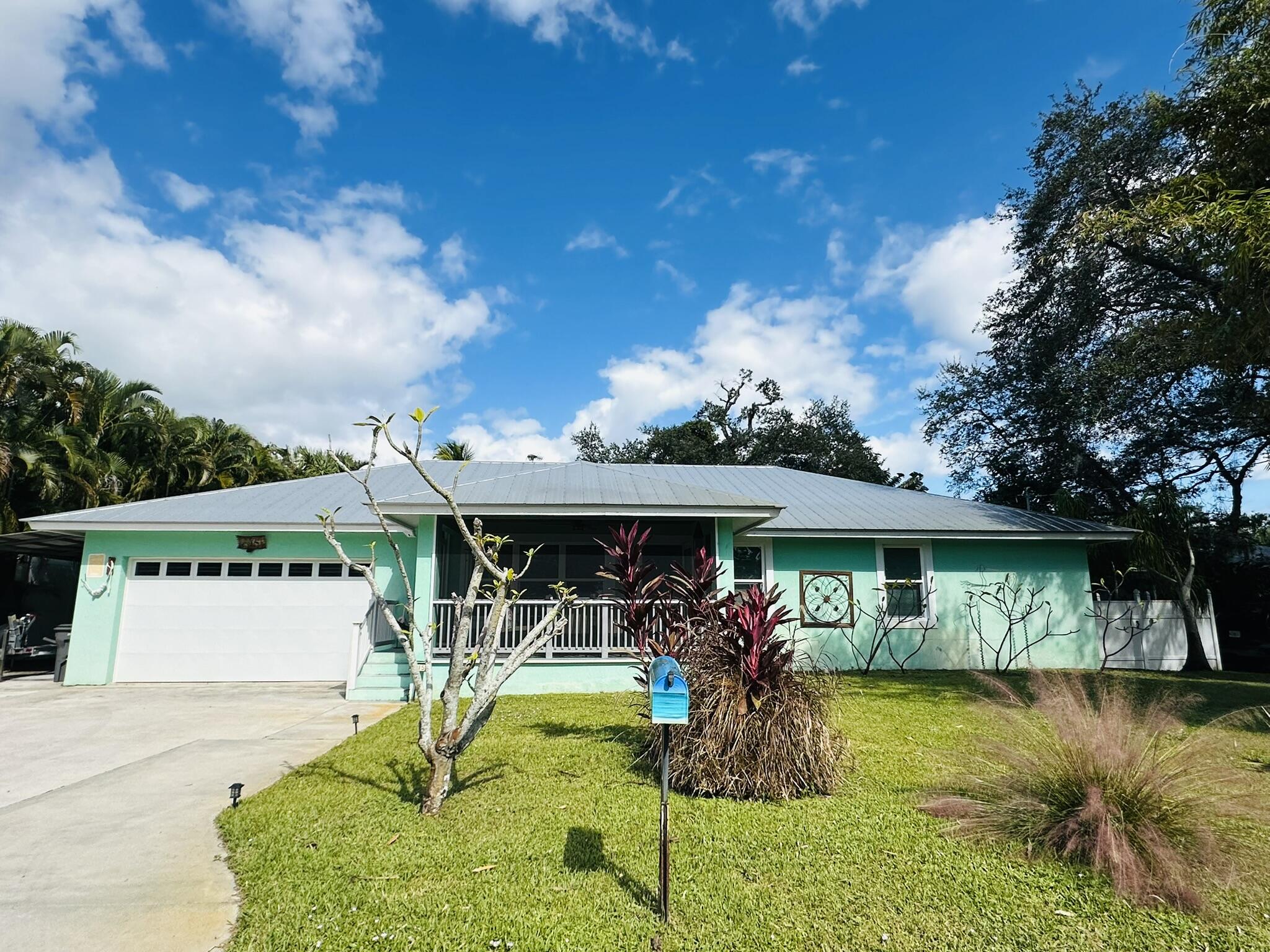 a view of a house with swimming pool and a yard