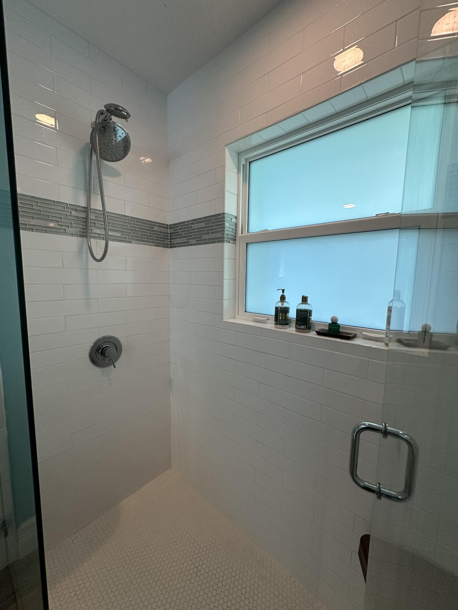 2415 Laurel Lane Palm Beach Gardens, FL 33410 - Photo 12 of 18 a bathroom with a shower and a mirror