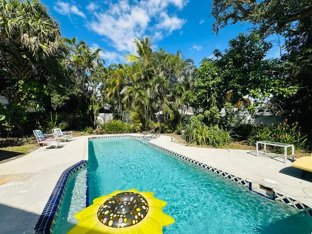 a view of a swimming pool with a yard