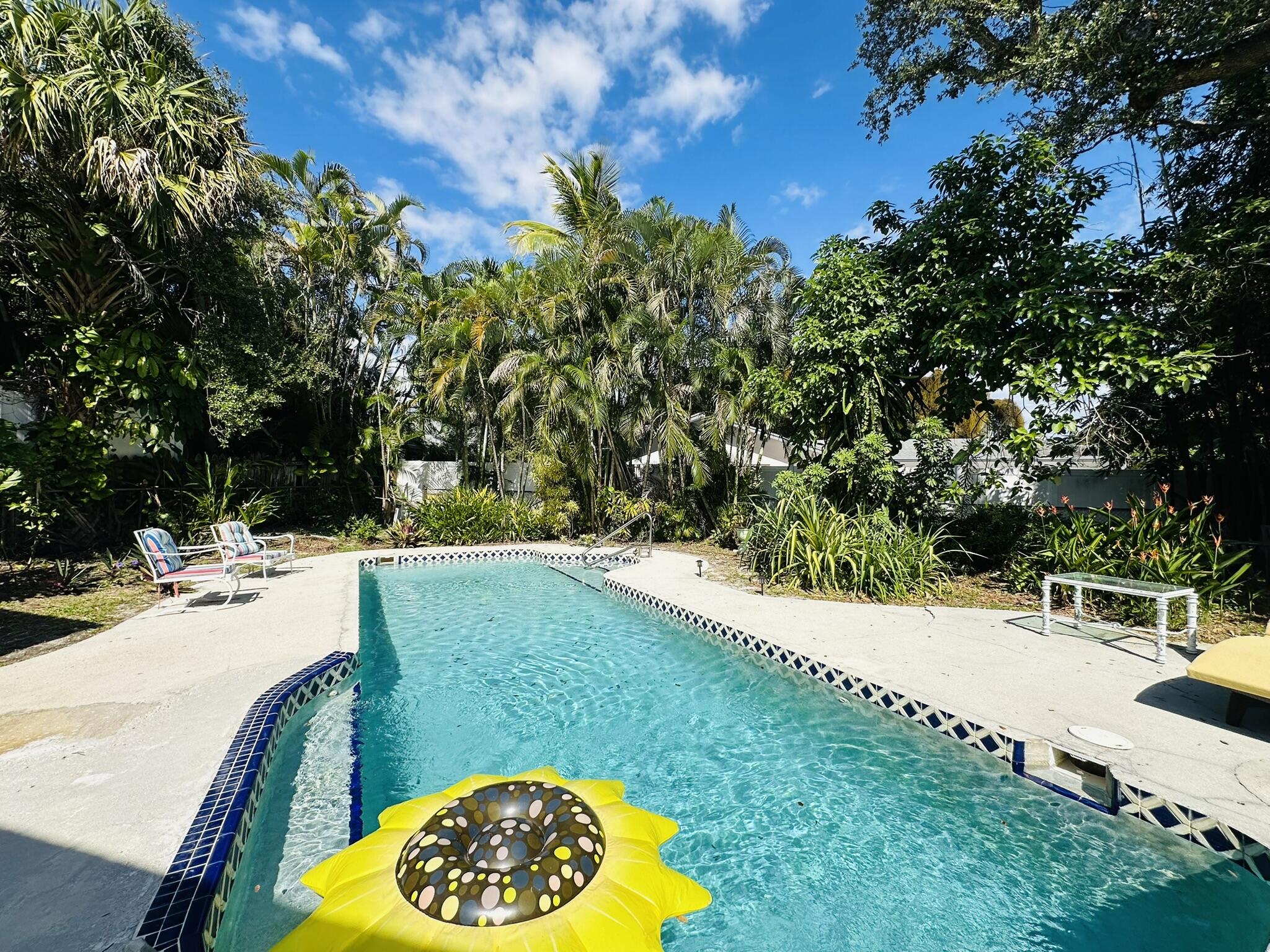 2415 Laurel Lane Palm Beach Gardens, FL 33410 - Photo 3 of 18 a view of a swimming pool with a yard
