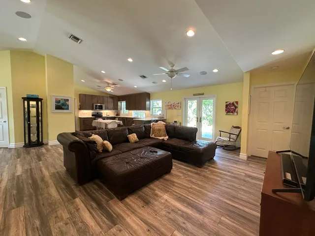 a living room with furniture and wooden floor