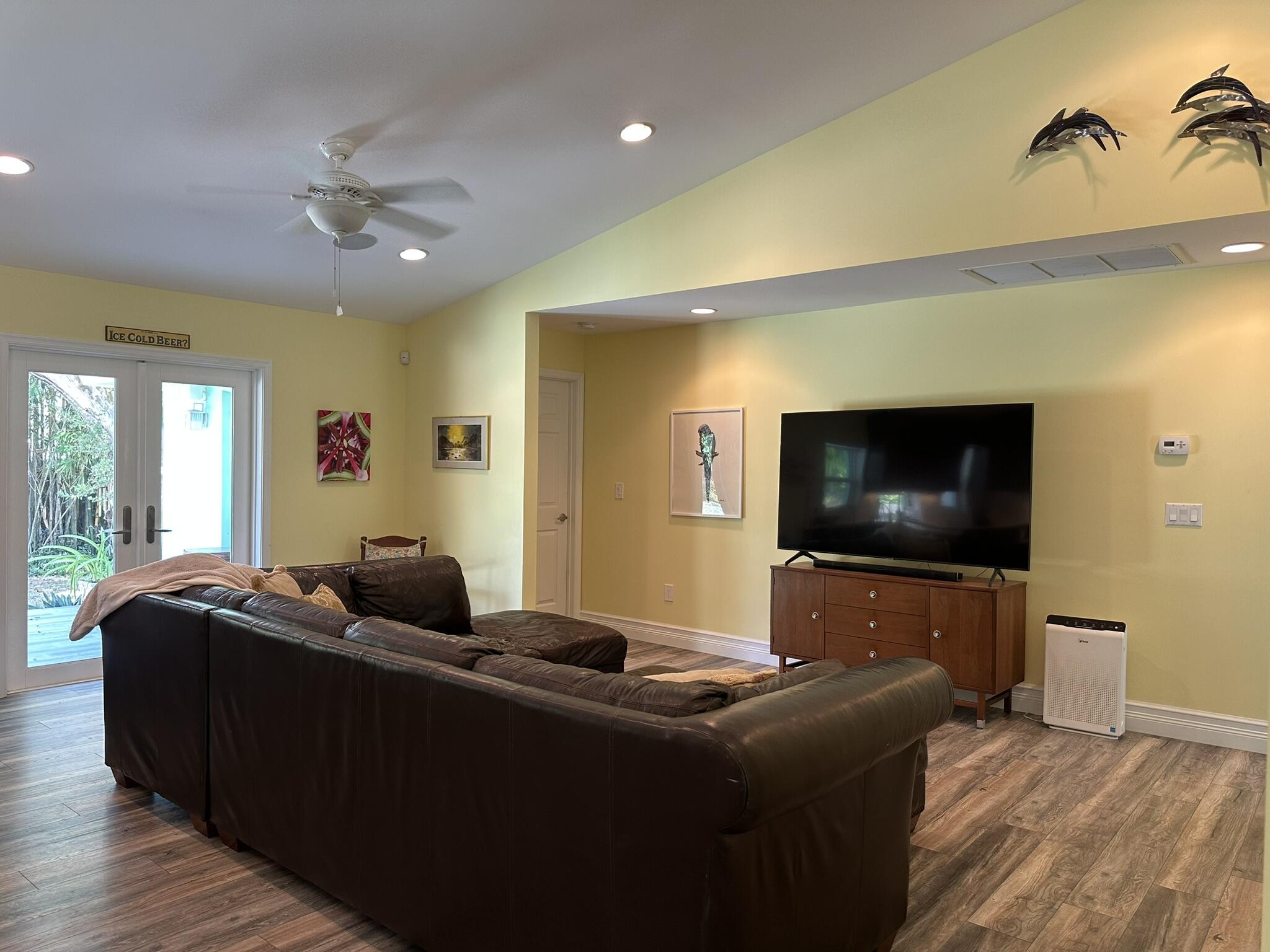 2415 Laurel Lane Palm Beach Gardens, FL 33410 - Photo 7 of 18 a living room with furniture and a flat screen tv