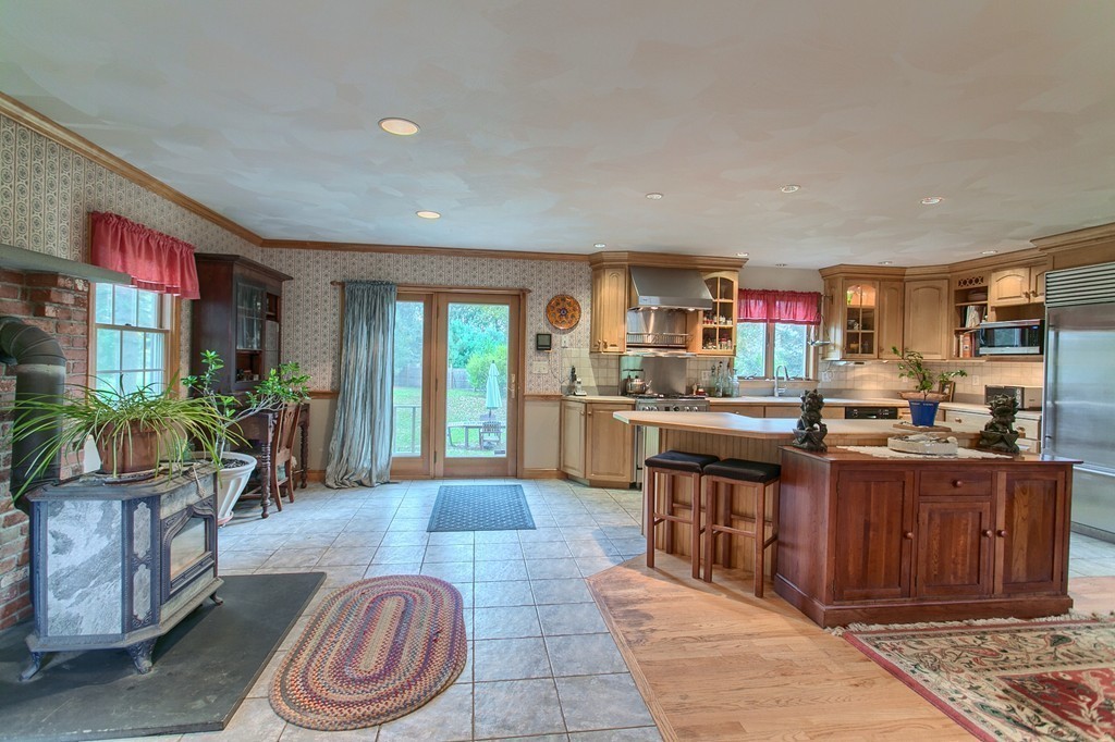 309 Boston Road Groton, MA 01450 - Photo 7 of 21 a large kitchen with stainless steel appliances granite countertop a stove a sink dishwasher and a dining table with garden view