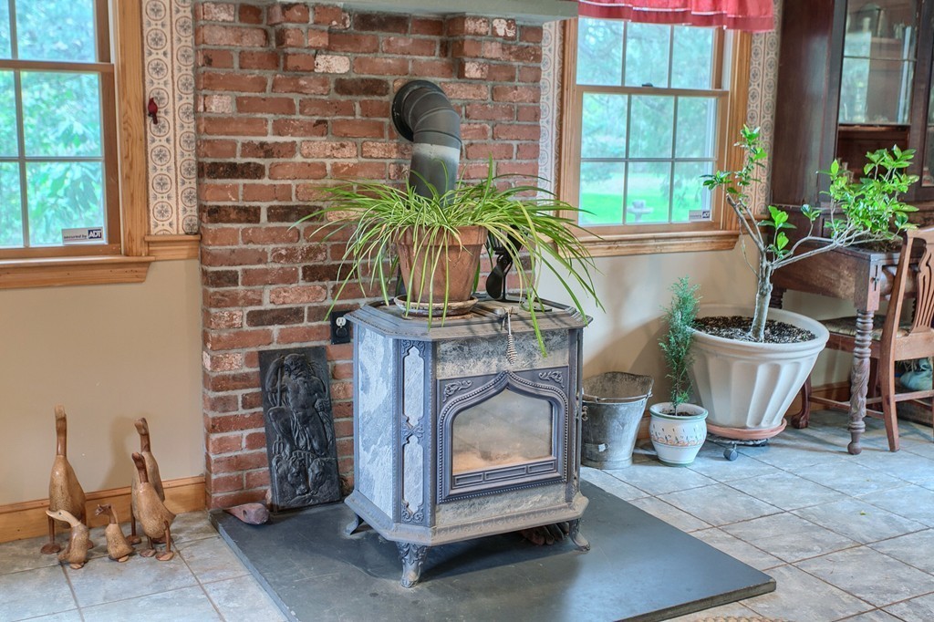 309 Boston Road Groton, MA 01450 - Photo 8 of 21 a living room with furniture a potted plant and a fireplace