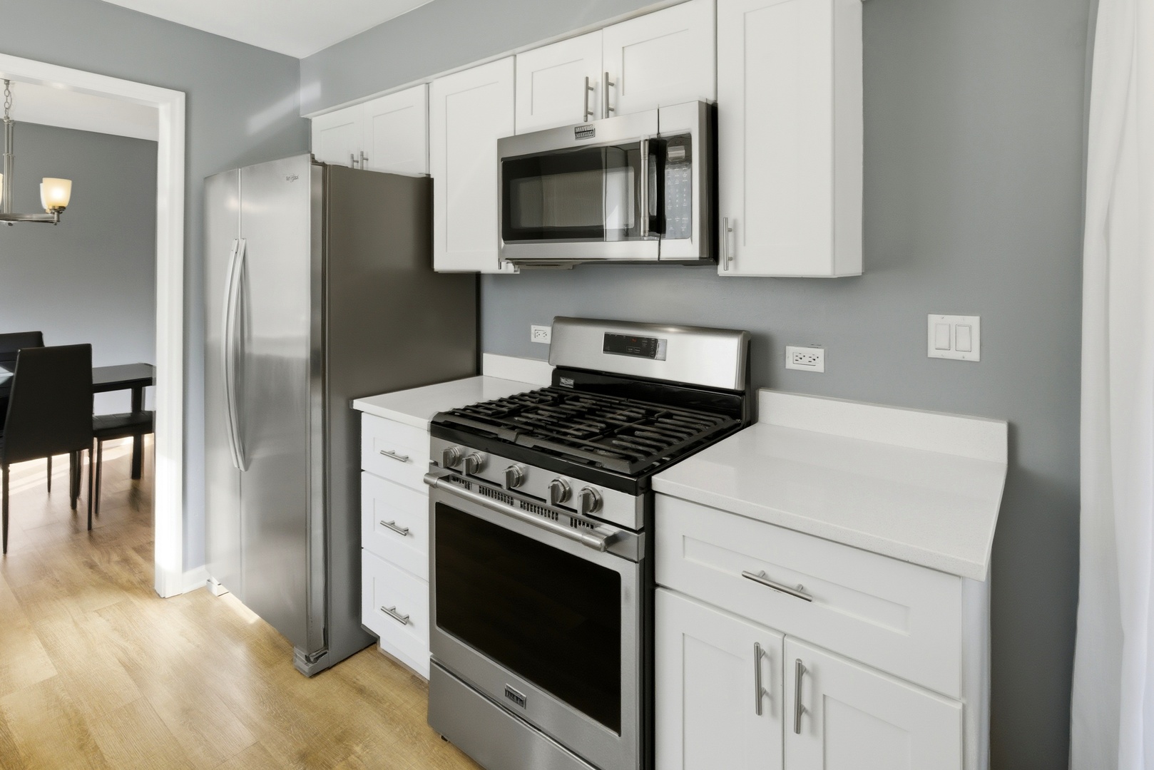 622 Zaininger Avenue, Unit A Naperville, IL 60563 - Photo 11 of 30 a kitchen with stainless steel appliances white cabinets a stove top oven