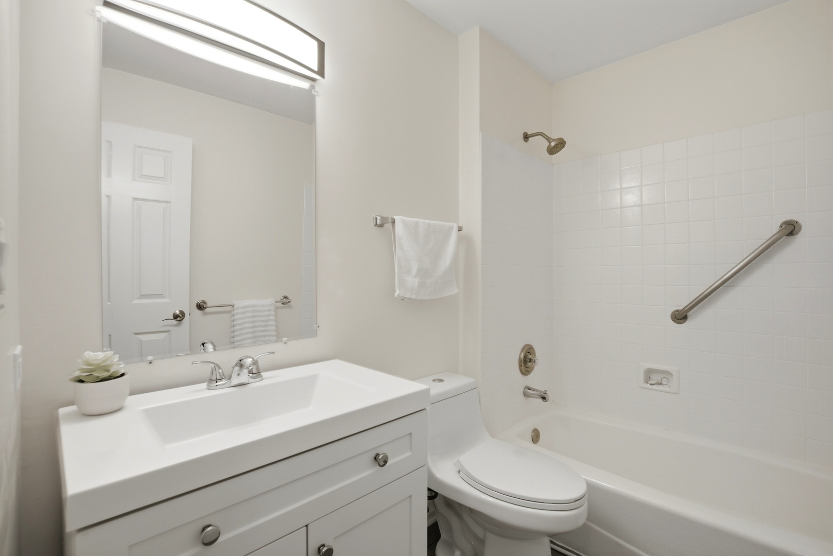 622 Zaininger Avenue, Unit A Naperville, IL 60563 - Photo 22 of 30 a bathroom with a sink a toilet and a mirror