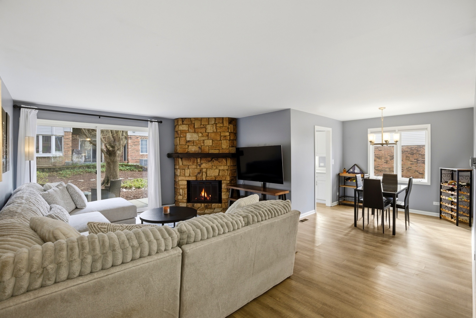 622 Zaininger Avenue, Unit A Naperville, IL 60563 - Photo 3 of 30 a living room with fireplace furniture and a flat screen tv