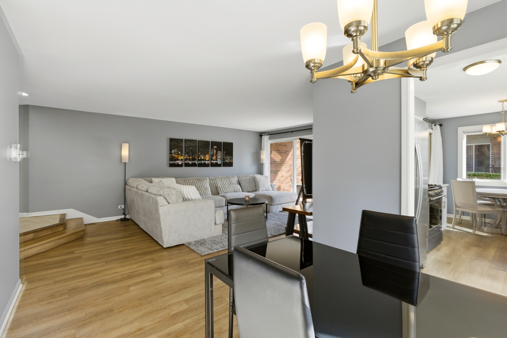 622 Zaininger Avenue, Unit A Naperville, IL 60563 - Photo 6 of 30 a bed room with a bed and a chandelier
