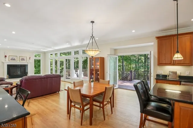 a dining room with furniture a chandelier and fireplace