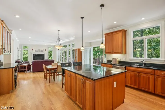 a kitchen with stainless steel appliances granite countertop sink stove and wooden floor