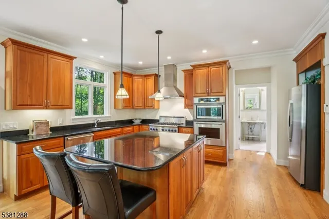 a kitchen with counter top space a sink appliances and cabinets