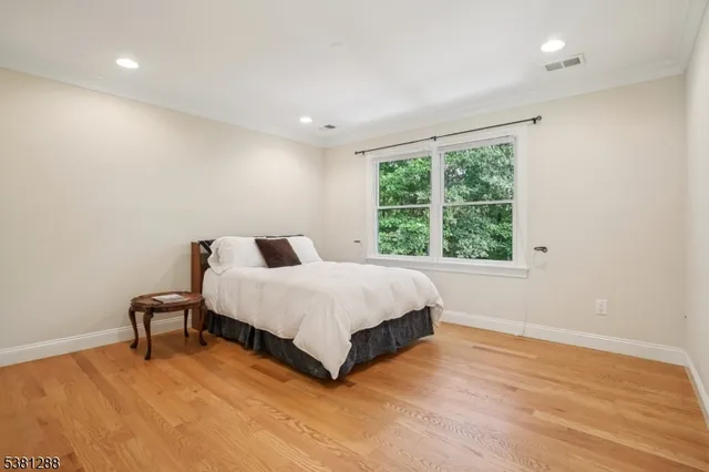 a spacious bedroom with a bed and a window