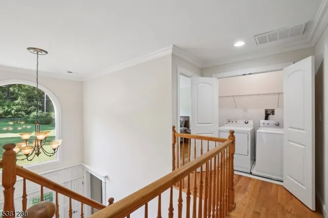 a view of a hallway with furniture and stairs