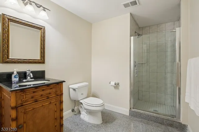 a bathroom with a toilet a sink and shower