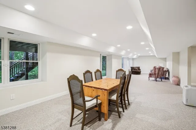 a dining room with furniture and a floor to ceiling window