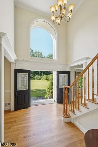 a view of an entryway with a floor to ceiling window and a fireplace