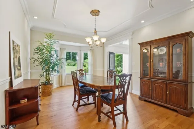 a view of a dining room with furniture and chandelier