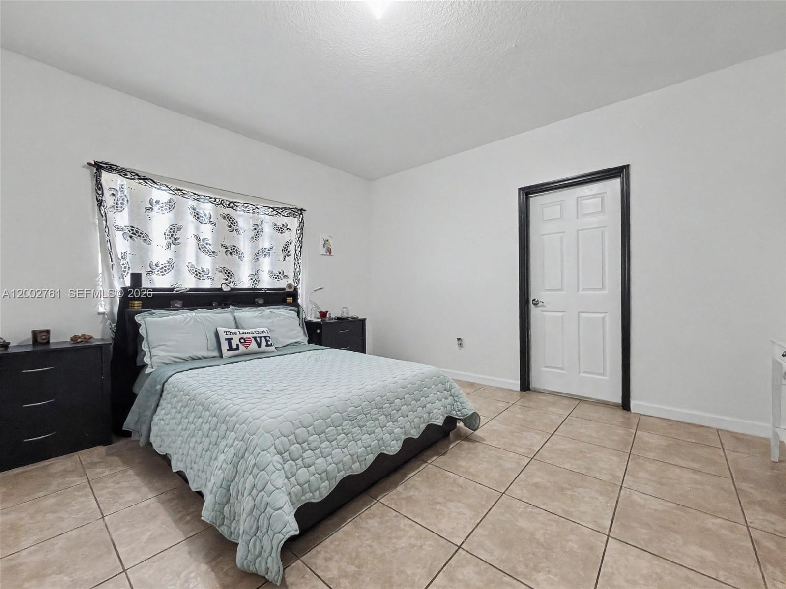 14264 Southwest 289th Terrace Homestead, FL 33033 - Photo 16 of 23 a bedroom with a bed and a window