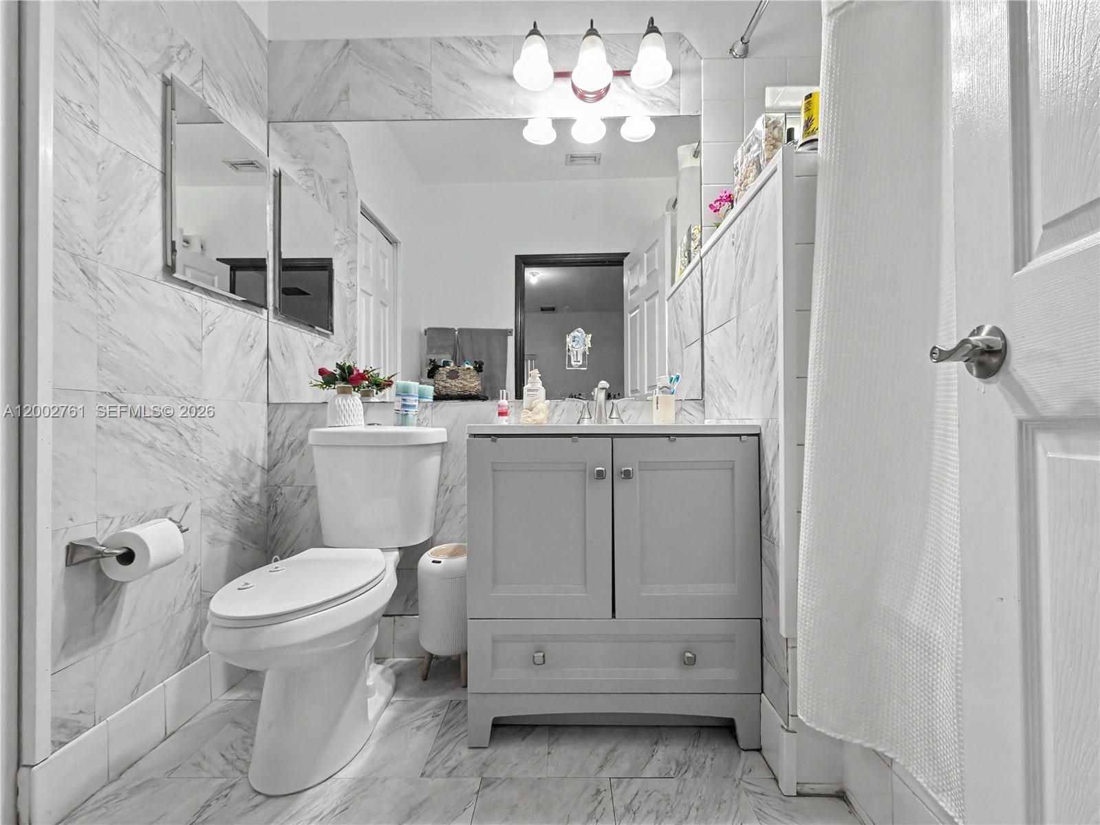14264 Southwest 289th Terrace Homestead, FL 33033 - Photo 17 of 23 a bathroom with a sink a toilet and a mirror
